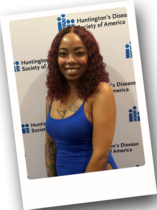 Rashawnda standing and smiling at a Hungtinton's Disease Society of America event.